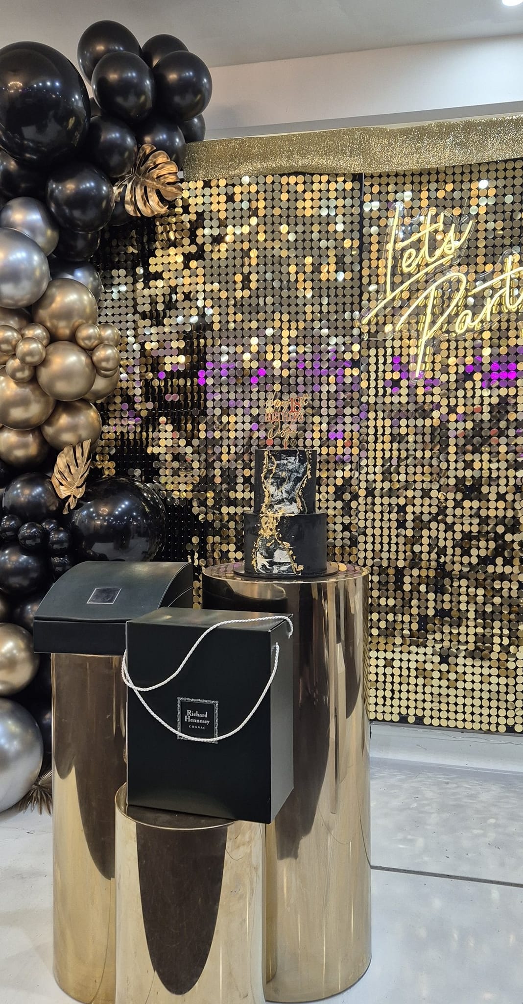 Gold and black adult party styling with pedestal details