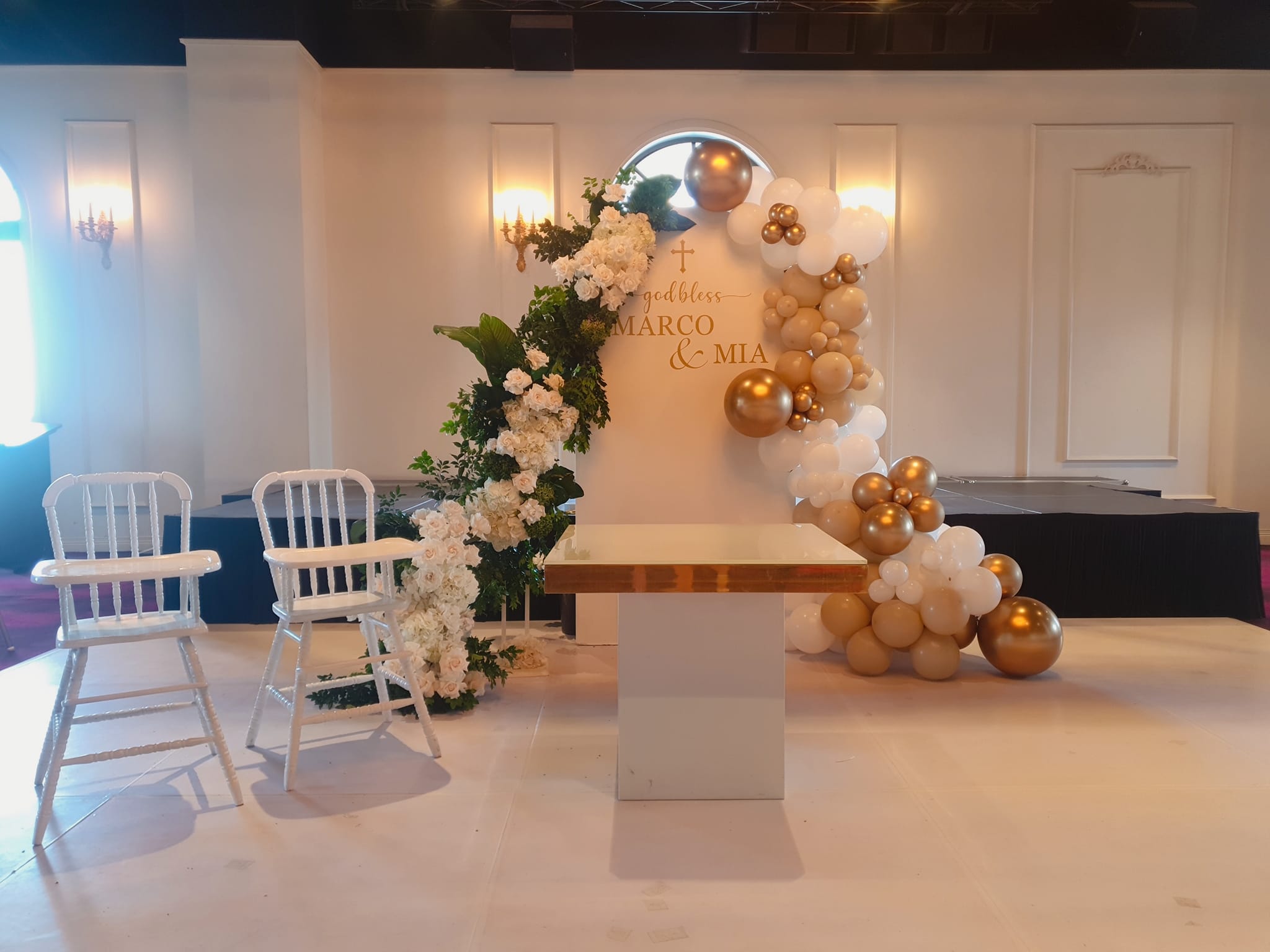 Child baptism setup with gold and white balloons
