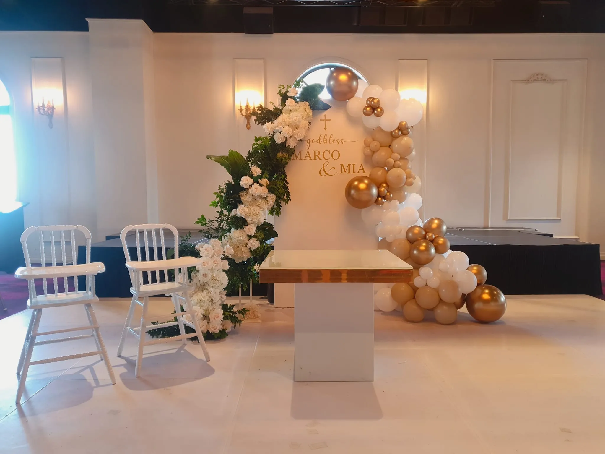 Child baptism setup with gold and white balloons