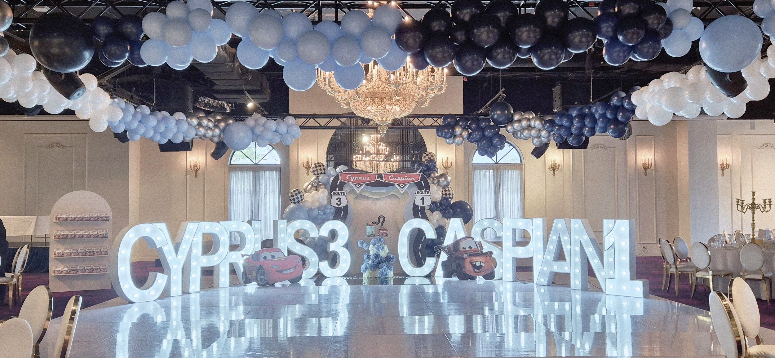 Disney Cars themed birthday setup in a large hall